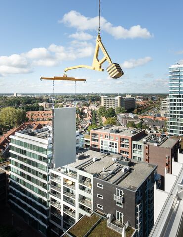 Modulares Gebäudepaneel neben dem Wolkenkratzer angehoben.